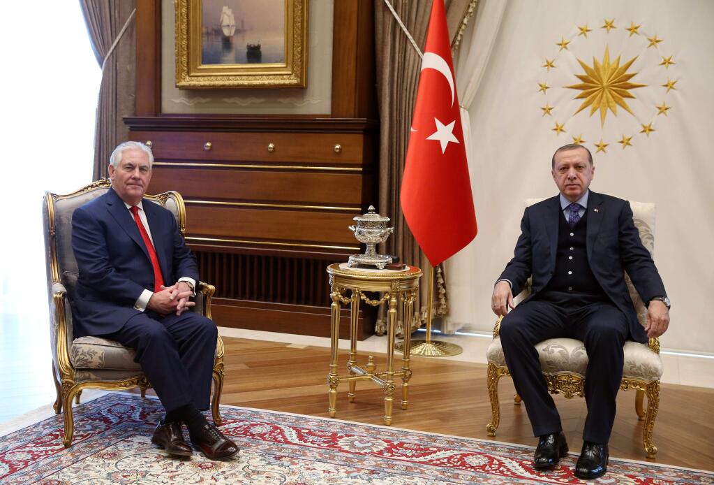 U.S. Secretary of State Rex Tillerson, left, poses with Turkey's President Recep Tayyip Erdogan at the start of their meeting in Ankara, Turkey, Thursday, March 30, 2017. Tillerson met Turkish leaders on Thursday, a day after Turkey said it has ended a military operation in northern Syria amid differences with the United States over how to fight the Islamic State group there. (Presidential Press Service/Pool Photo via AP)