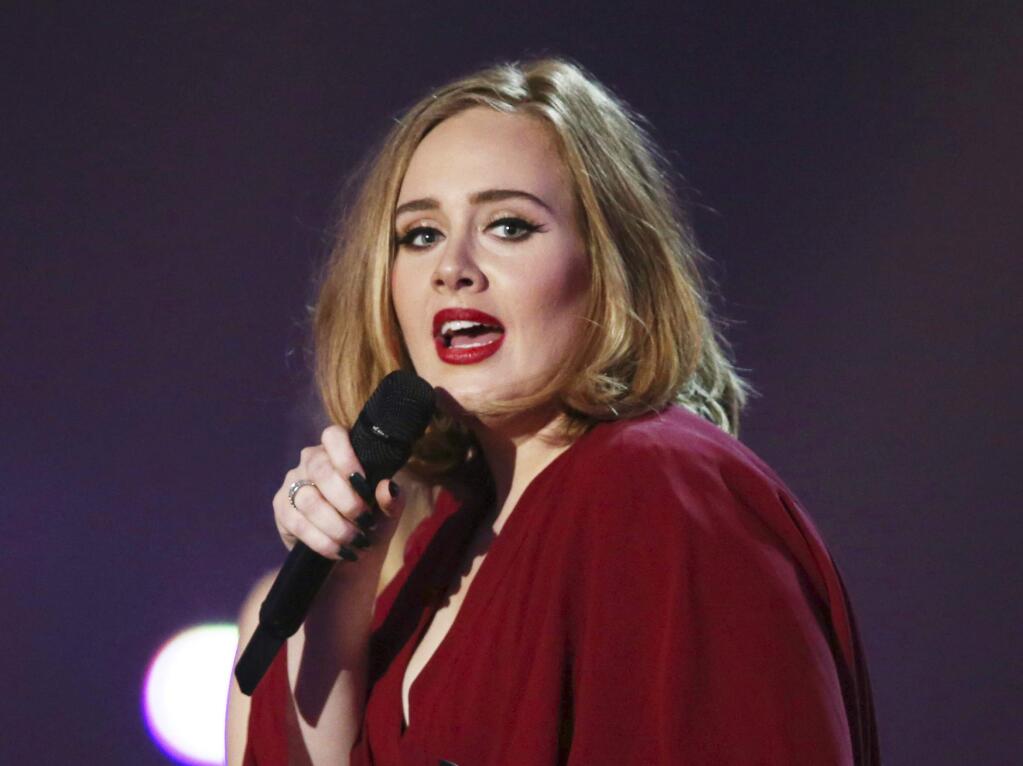 FILE - In this Feb. 24, 2016 file photo shows Adele onstage at the Brit Awards 2016 at the 02 Arena in London. Adele, who has five Grammy nominations, announced Tuesday, Dec. 6, including album, song and record of the year. (Photo by Joel Ryan/Invision/AP, File)