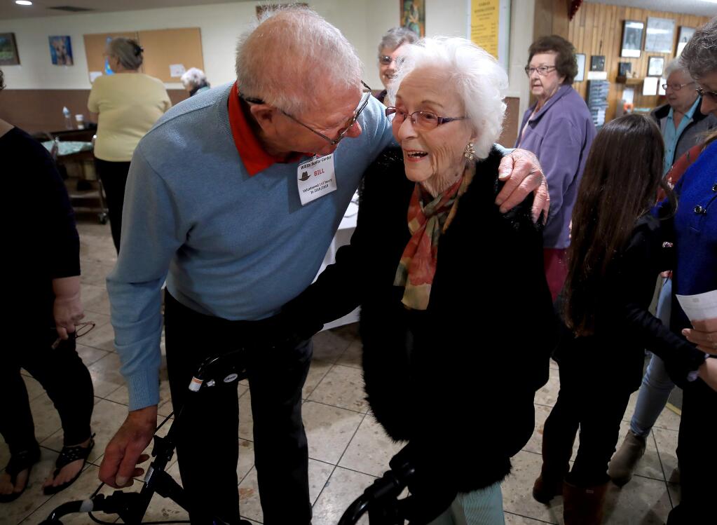 Willits Senior Center volunteer Bill Barker, left, greets Edith Ceccarelli at her birthday party, turning 112, Wednesday, Feb. 5, 2020 in Willits. (Kent Porter / The Press Democrat) 2020