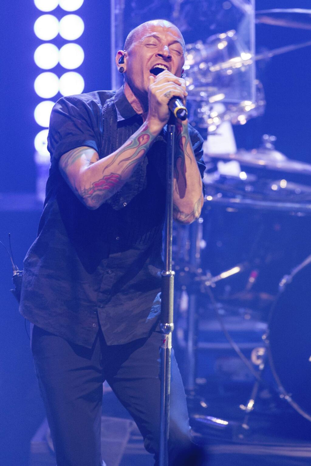 FILE - In this June 18, 2014 file photo, Chester Bennington of Linkin Park performs during the iHeartRadio Live Series in Burbank, Calif. The Los Angeles County coroner says Bennington, who sold millions of albums with a unique mix of rock, hip-hop and rap, has died in his home near Los Angeles. He was 41. Coroner spokesman Brian Elias says they are investigating Bennington's death as an apparent suicide but no additional details are available. (Photo by Paul A. Hebert/Invision/AP, File)