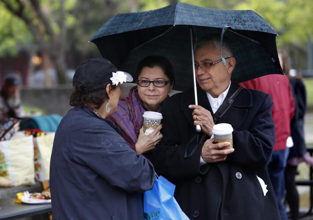 Gloria Huerta, left, talks with Martha and Bob Renteria during a free brunch organized by the SOMA Church Community at Old Courthouse Square on Sunday, April 5, 2015 in Santa Rosa, California . (BETH SCHLANKER/ The Press Democrat)