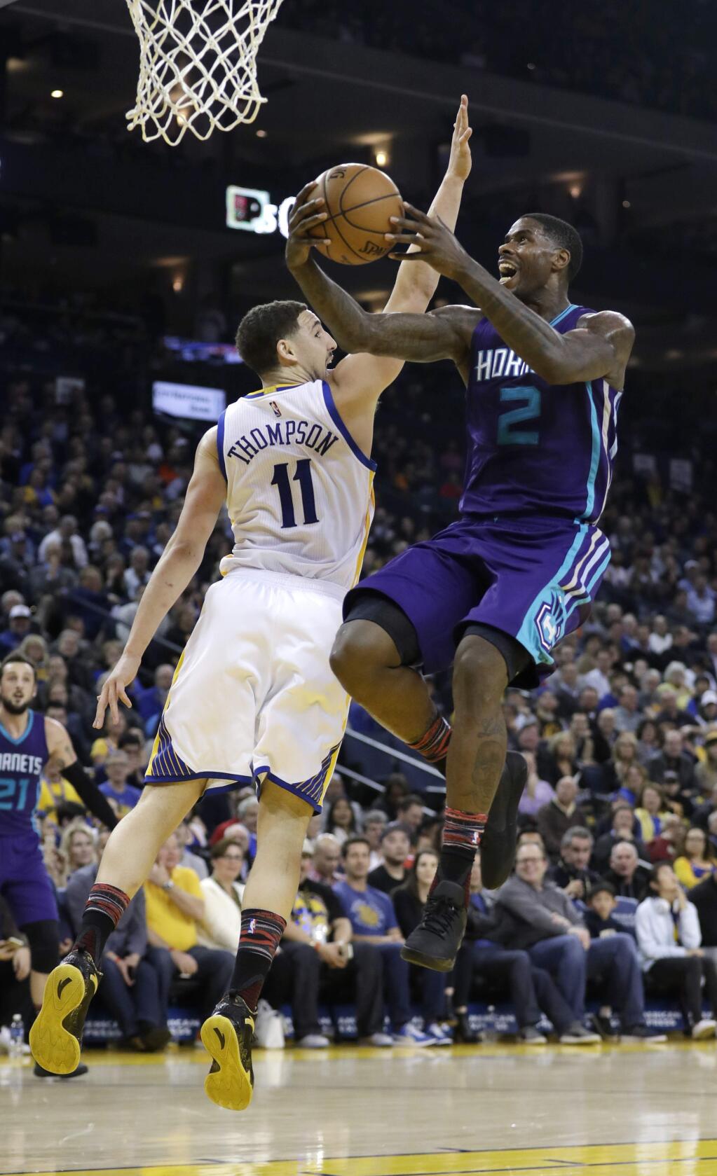 Charlotte Hornets' Marvin Williams (2) drives past Golden State Warriors' Klay Thompson (11) during the first half of an NBA basketball game Wednesday, Feb. 1, 2017, in Oakland, Calif. (AP Photo/Marcio Jose Sanchez)
