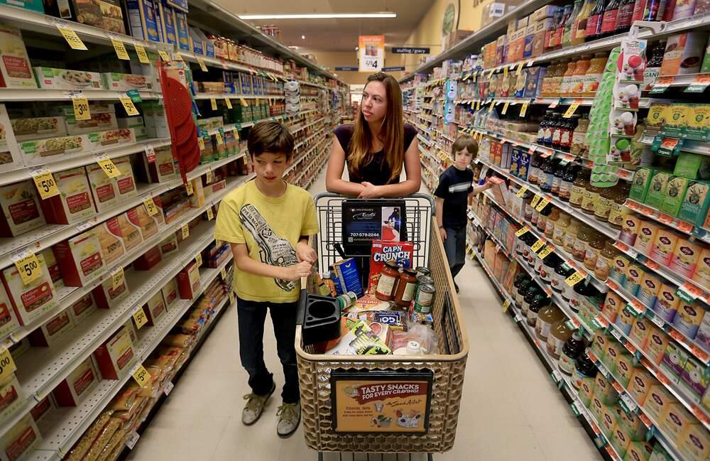 Amber Barretto, middle, shops with her children Lawrence, 10 and Christopher, 8, at Safeway in Windsor, Thursday Aug. 8, 2013. (Kent Porter / Press Democrat) File 2013