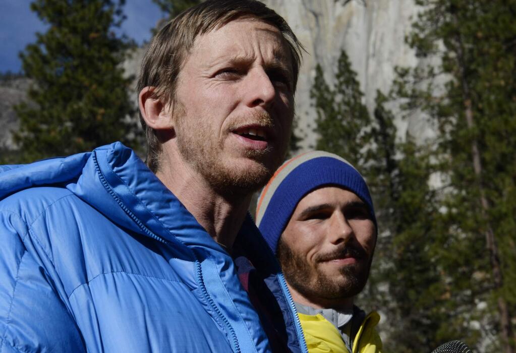 Climbers Tommy Caldwell, left, and Kevin Jorgeson, right, speak during a press conference in Yosemite Valley near the base of El Capitan Thursday morning, Jan. 15, 2015 in Yosemite National Park. The two Americans became the first to free-climb El Capitan's Dawn Wall. They used ropes and safety harnesses in case of a fall but relied only on their hands, feet and strength to reach the 3,000-foot summit the day before. The trek began Dec. 27. (AP Photo/The Fresno Bee, Eric Paul Zamora)