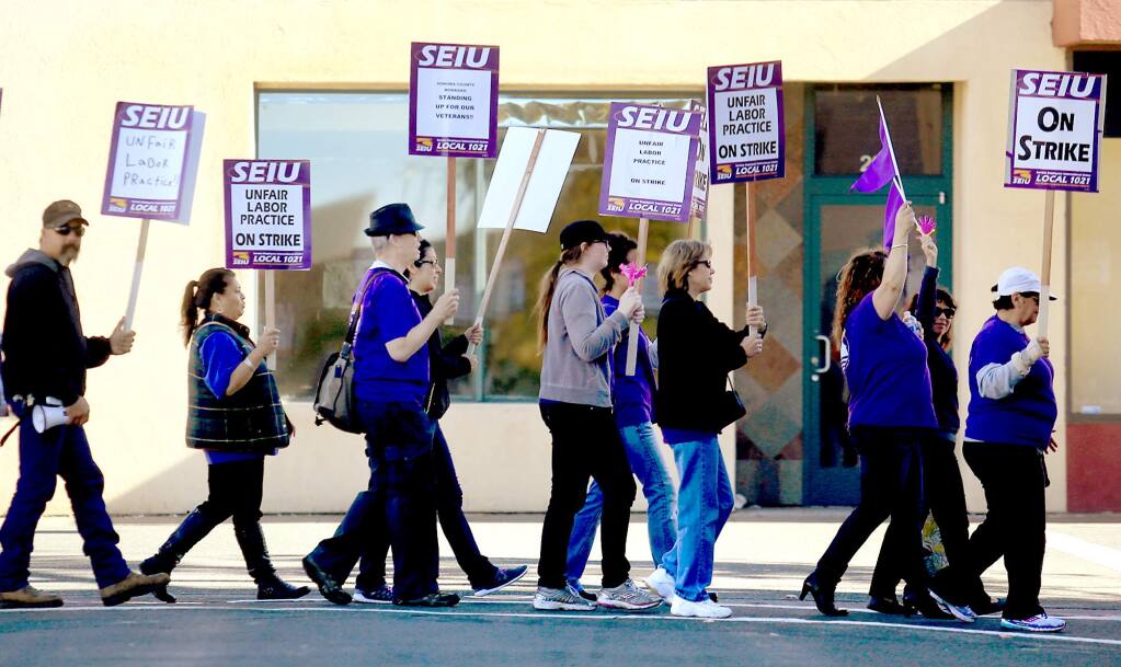Service Employees International Union Local 1021 protest in downtown Santa Rosa, Thursday Nov. 19, 2015, the final day of their three-day strike. (Kent Porter / Press Democrat)