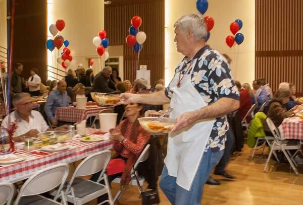 Chris Albertson delivers salad at a prior Petaluma Rotary Clubs crab feed. (JOHN O'HARA/FOR THE ARGUS-COURIER)