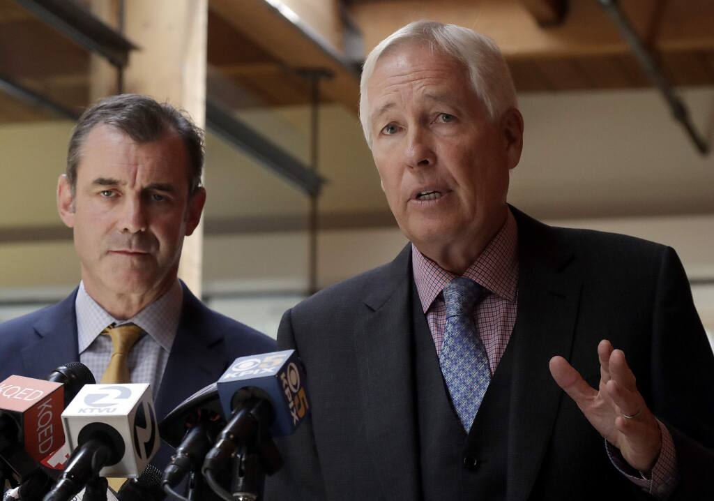 Attorneys Robert Arns, right, and Jonathan Davis, representing the family of Nia Wilson, speak at a news conference in San Francisco, Friday, Aug. 17, 2018. The family of Nia Wilson, who was stabbed to death at a subway station in Oakland, Calif., on July 22, 2018, is taking the first legal step toward suing the Northern California public transit system. Arns said his law firm delivered a legal claim Friday to the Bay Area Rapid Transit on behalf of the family of 18-year-old Wilson. (AP Photo/Jeff Chiu)