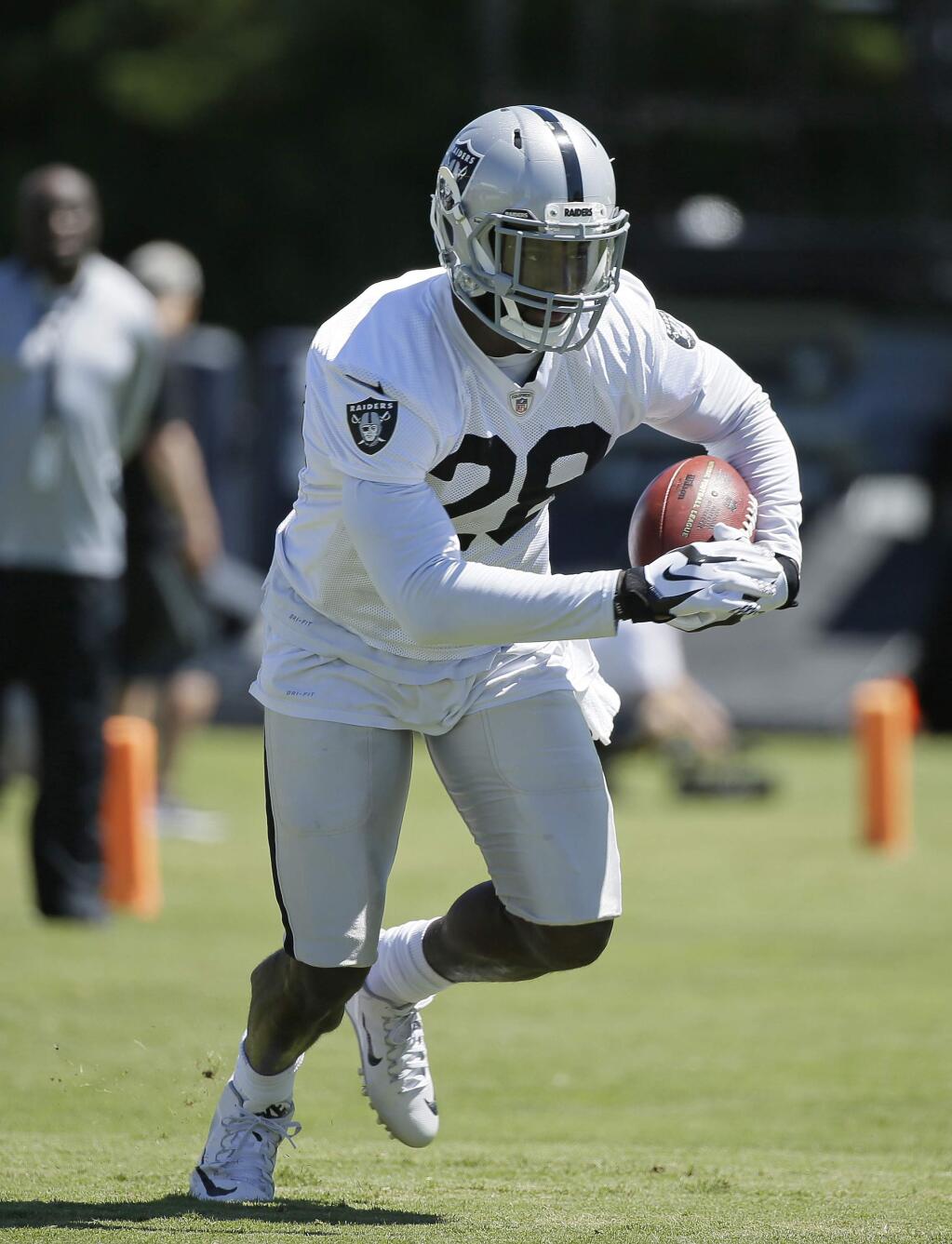 In this July 30, 2016 file photo, Oakland Raiders running back Latavius Murray runs with the ball during practice at training camp in Napa. Murray is counting on more help at running back leading to more big runs of his own this season for the Raiders. (AP Photo/Eric Risberg, File)
