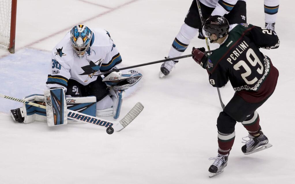San Jose Sharks goalie Aaron Dell, left, blocks a shot by Arizona Coyotes left wing Brendan Perlini during the second period Saturday, Feb. 18, 2017. (AP Photo/Chris Carlson)