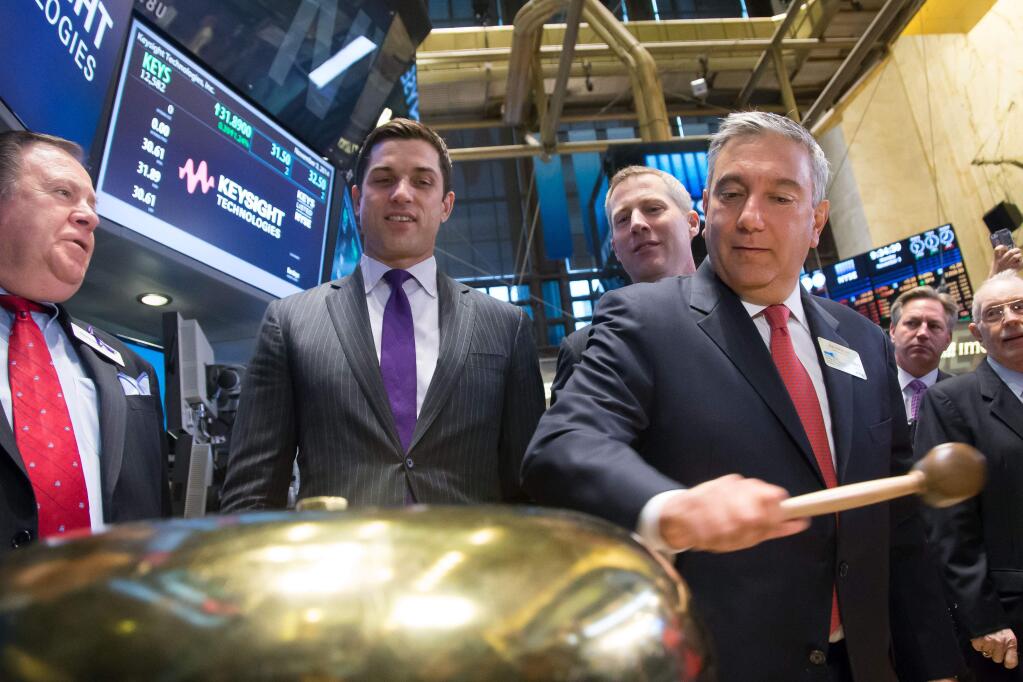 Keysight Technologies executives, led by President and CEO Ron Nersesian, visited the New York Stock Exchange in 2014. (Photo by Ben Hider/NYSE)