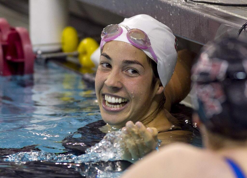 Stanford's Maya DiRado smiles after winning the 400-yard individual medley at the NCAA women's swimming and diving championships in Minneapolis, Friday, March 21, 2014. (AP Photo/Andy Clayton-King)