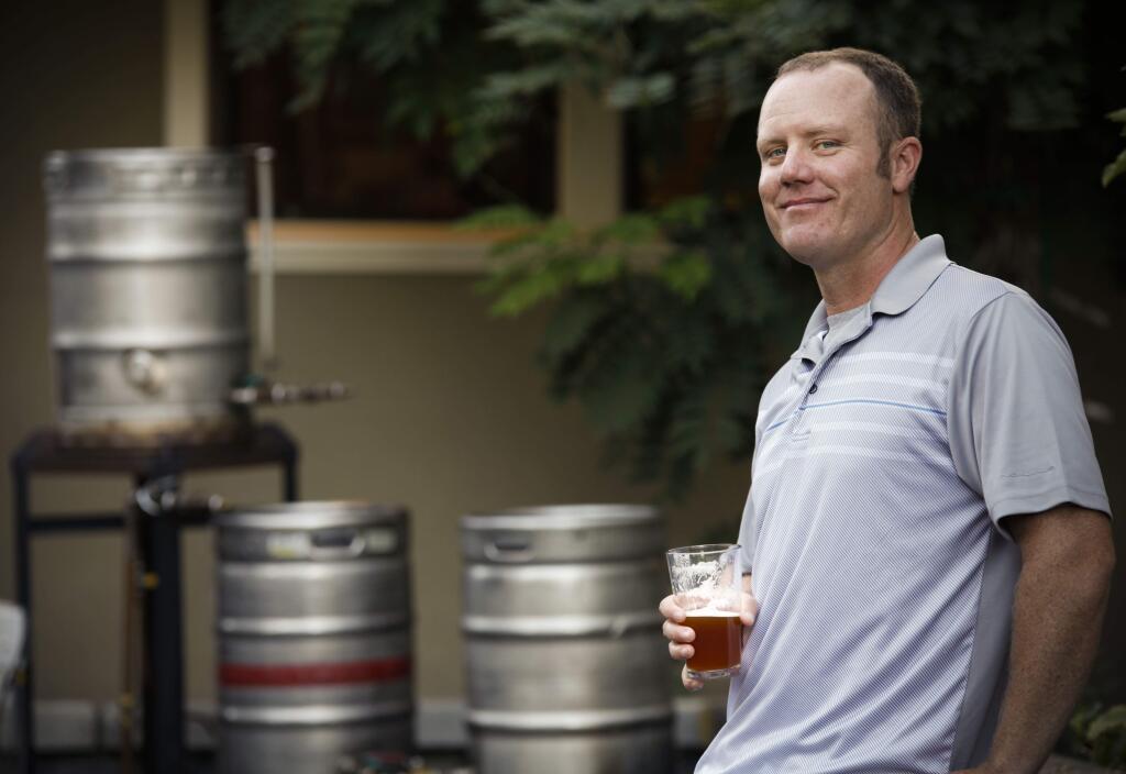 Petaluma, CA, USA. Tuesday, October 03, 2017._ Kevin Larson, 37, a firefighter with Petaluma Fire Dept, enjoys brewing beer at home. He uses a 10-gallon brewing system in his garage and often grows his own hops. He would like to open his own nano-brewery called Coastal Acres. This weekend, he will be participating in the 3rd annual Sonoma County Home Brewers Competition in Petaluma. (CRISSY PASCUAL/ARGUS-COURIER STAFF)