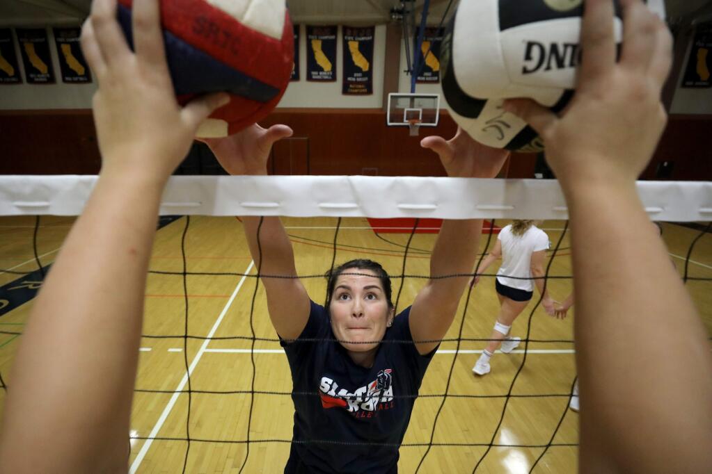 Jessica Crawford does a blocking drill as she practices with the volleyball team at Haehl Pavilion on the Santa Rosa Junior College campus in Santa Rosa on Monday, September 23, 2019. (BETH SCHLANKER/ The Press Democrat)