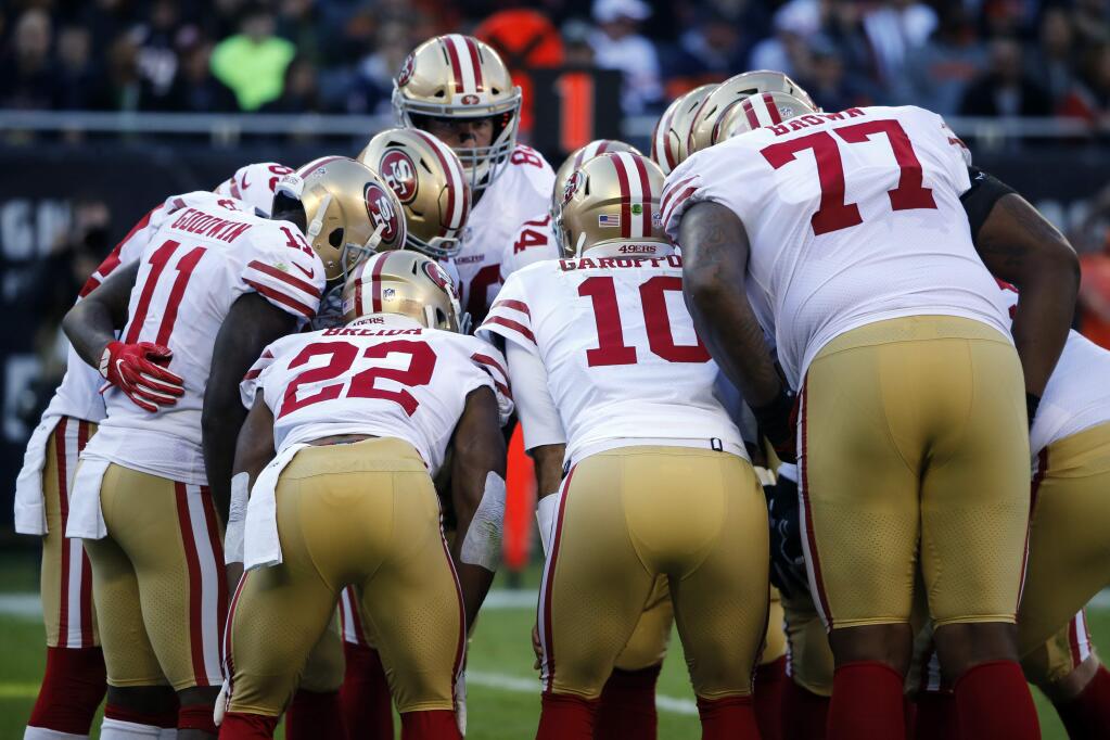 San Francisco 49ers players huddle during the first half against the Chicago Bears, Sunday, Dec. 3, 2017, in Chicago. (AP Photo/Charles Rex Arbogast)