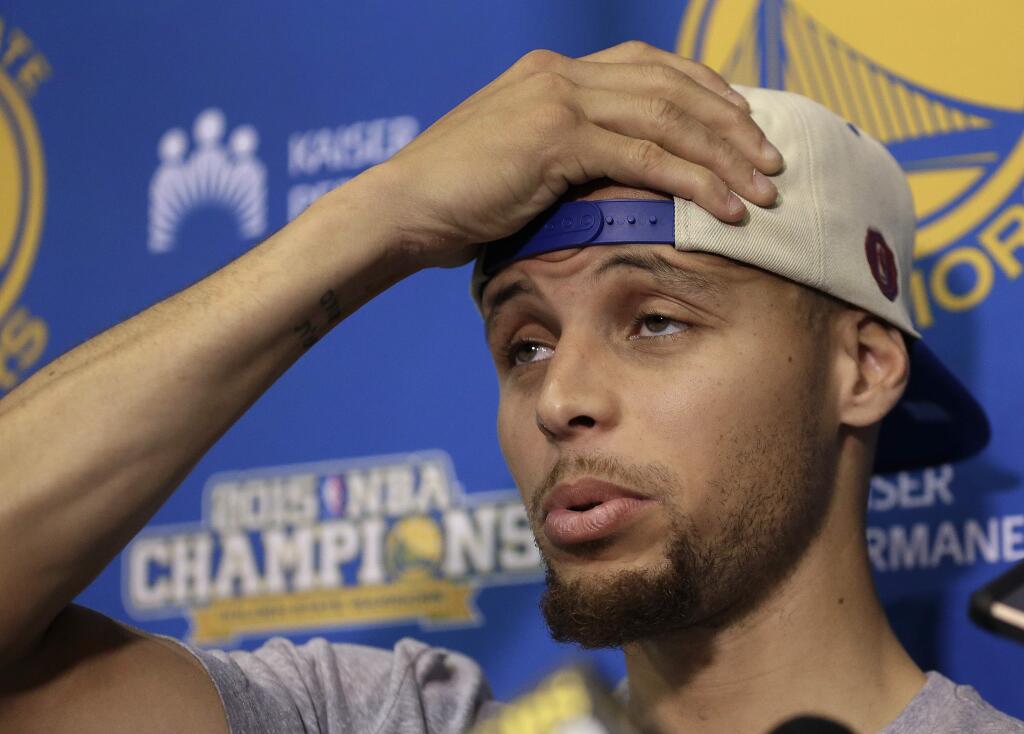 Golden State Warriors' Stephen Curry places his hand to his head during a news conference Monday, June 20, 2016, in Oakland, Calif. The Warriors lost to the Cleveland Cavaliers in Game 7 of basketball's NBA Finals on Sunday. (AP Photo/Ben Margot)
