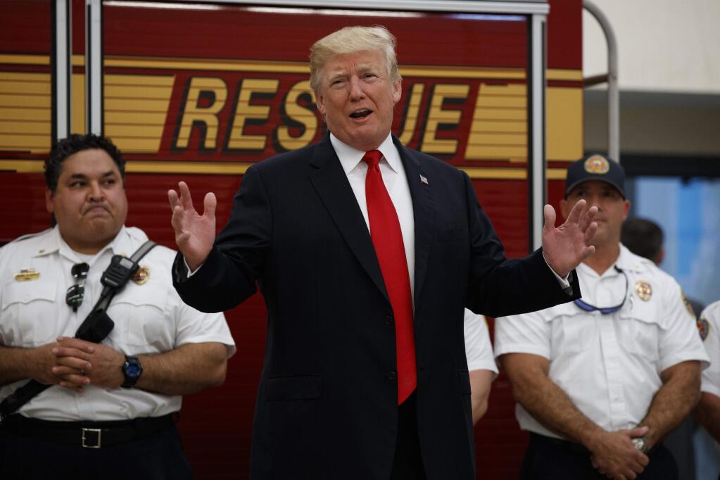 President Donald Trump speaks to first responders at West Palm Beach Fire Rescue, Wednesday, Dec. 27, 2017, in West Palm Beach, Fla. President Trump who is spending the holidays at his private Mar-a-Lago estate and club in Florida thanked the firefighters for their service. (AP Photo/Evan Vucci)