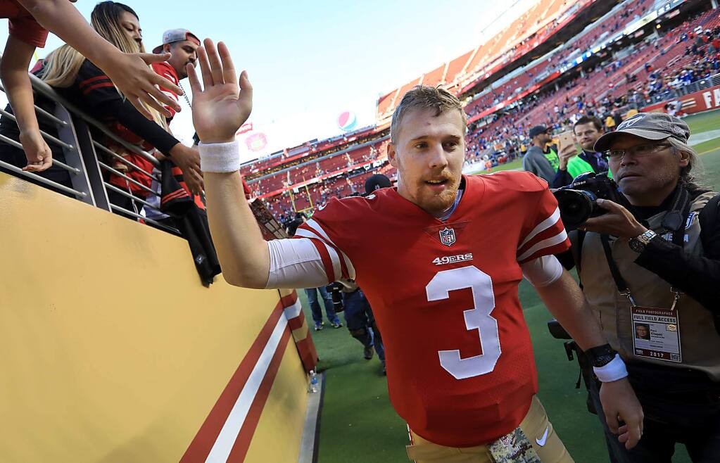 C.J. Beathard exchanges high-fives as the 49ers win their first game of the season, a 31-21 victory against the Giants in Santa Clara, Sunday Nov. 12, 2017. (Kent Porter / The Press Democrat)