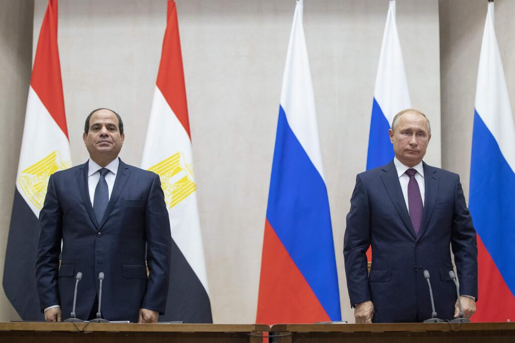 Russian President Vladimir Putin, right, and Egyptian President Abdel-Fattah el-Sisi pause during a minute of silence to commemorate the victims of an explosion in a vocational college in Crimea, during their talks in Sochi, Russia, Wednesday, Oct. 17, 2018. Russian President Vladimir Putin deplored the attack as a 'tragic event' and offered condolences to the victims' families at a news conference. (AP Photo/Pavel Golovkin, Pool)