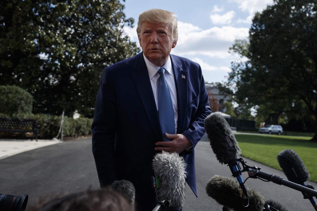 President Donald Trump talks to reporters on the South Lawn of the White House, Friday, Oct. 4, 2019, in Washington. (AP Photo/Evan Vucci)