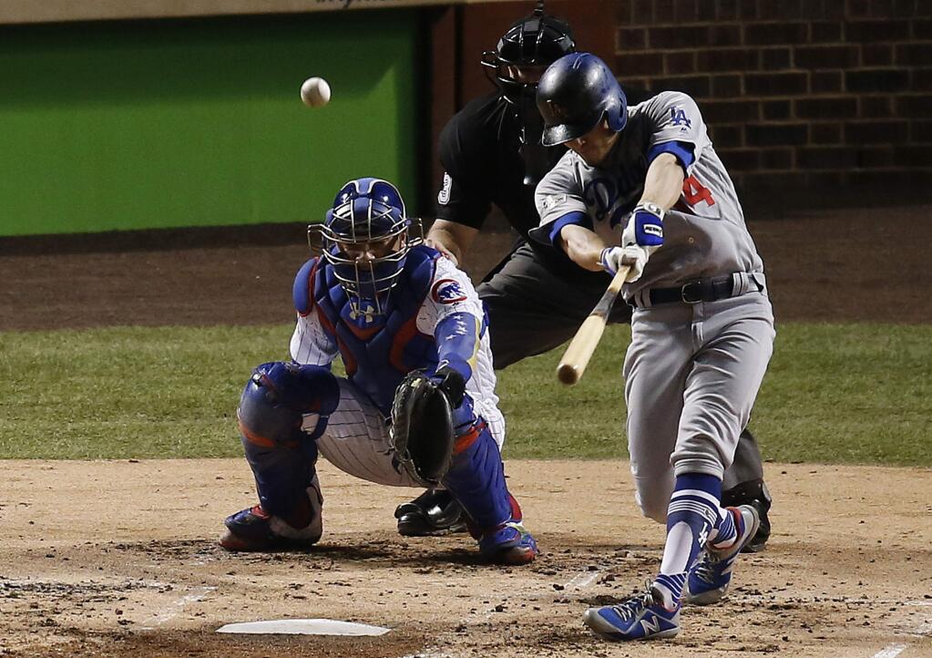 The Los Angeles Dodgers' Enrique Hernandez (14) hits a home run off Chicago Cubs starting pitcher Jose Quintana during the second inning of Game 5 of the National League Championship Series, Thursday, Oct. 19, 2017, in Chicago. (AP Photo/Charles Rex Arbogast)