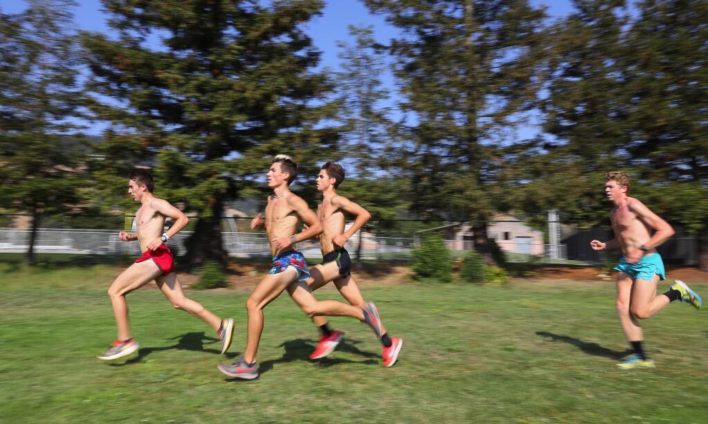 Maria Carrillo cross country runners Harrison Frankl, left, Colton Swinth, Rory Smail, and Owen Pugh run intervals during practice at Rincon Valley Community Park, in Santa Rosa on Monday, August 20, 2018. (Christopher Chung/ The Press Democrat)