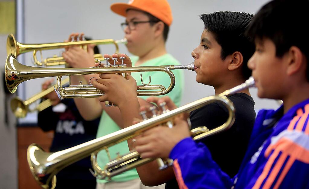 Emiliano Arellano, middle, shares the platform with Miguel Moreno, left and Fabian Peralta at Luther Burbank Center for the Arts sponsored Mariachi Camp at Lawrence Cook Middle School in Santa Rosa, Tuesday July 12, 2016. (Kent Porter / Press Democrat) 2016