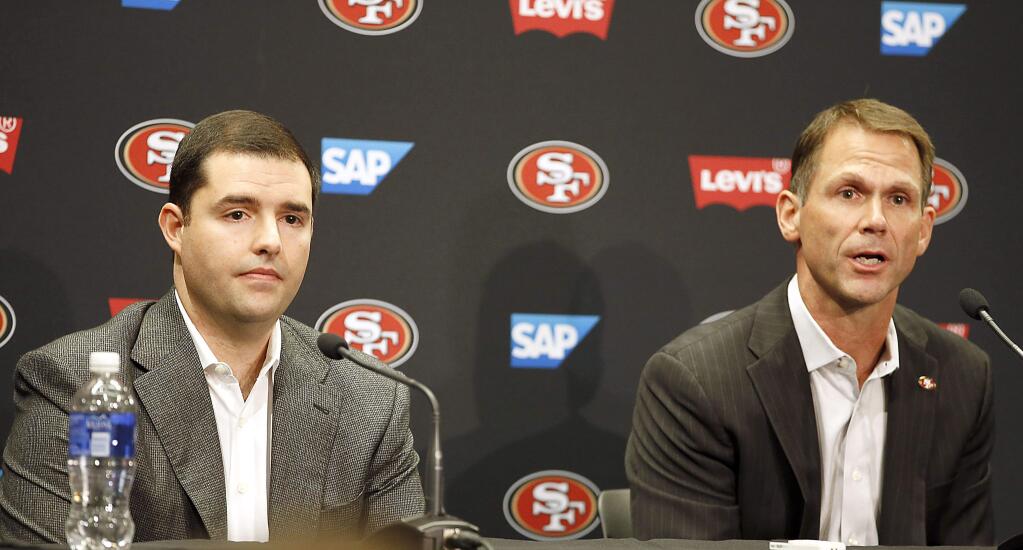 49ers owner Jed York, left, looks on as general manager Trent Baalke, right, speaks during a news conference at 49ers football headquarters in Santa Clara. (Tony Avelar / Associated Press)
