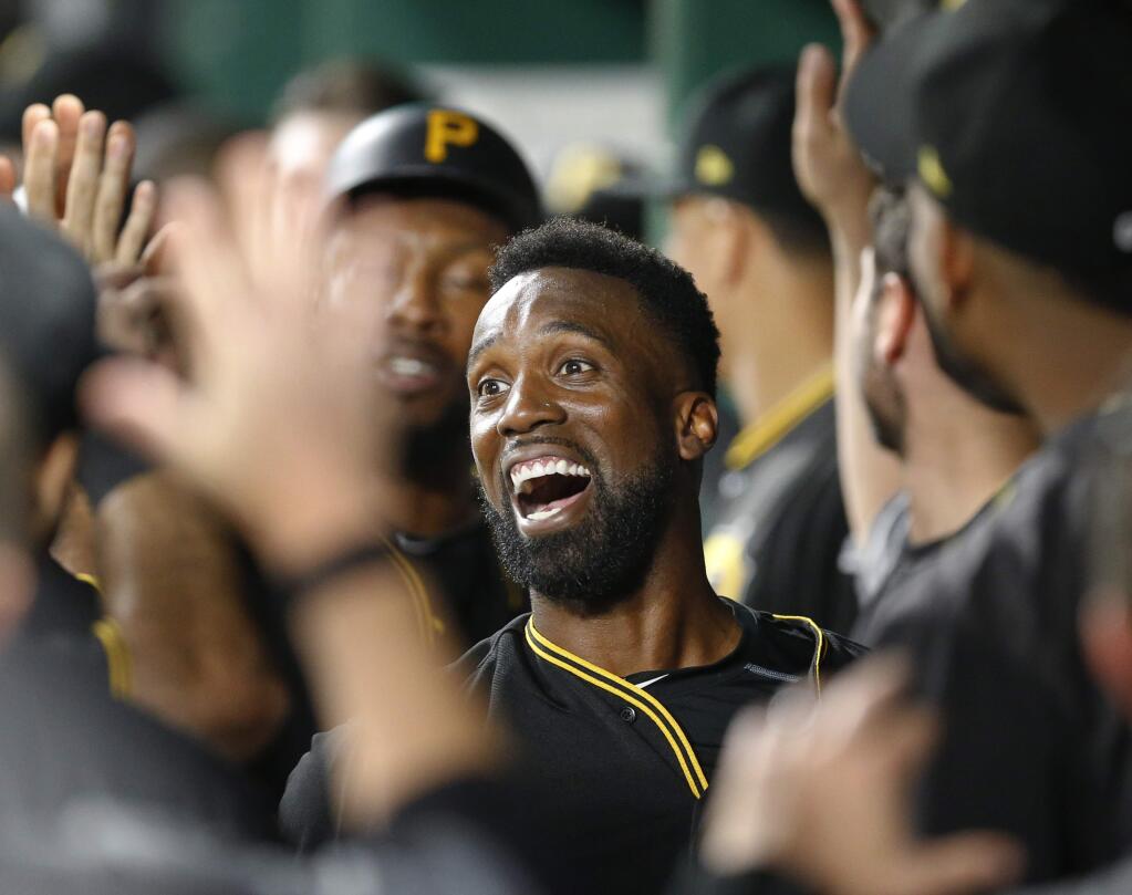 The Pittsburgh Pirates' Andrew McCutchen celebrates his first career grand slam in the dugout with teammates in the second inning against the Baltimore Orioles on Tuesday, Sept. 26, 2017, in Pittsburgh. (AP Photo/Keith Srakocic)