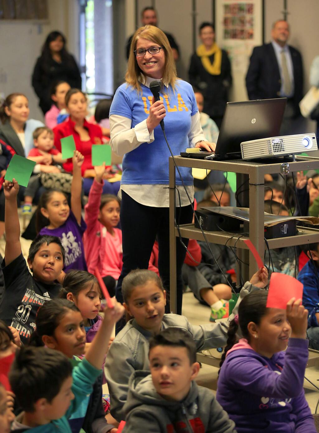 Santa Rosa City Schools board member Jenni Klose quizzes second- and third-grade Helen Lehman elementary school students about professions needing a college degree. Klose founded The College Tee Project to encourage young students to attend college. (JOHN BURGESS / The Press Democrat)