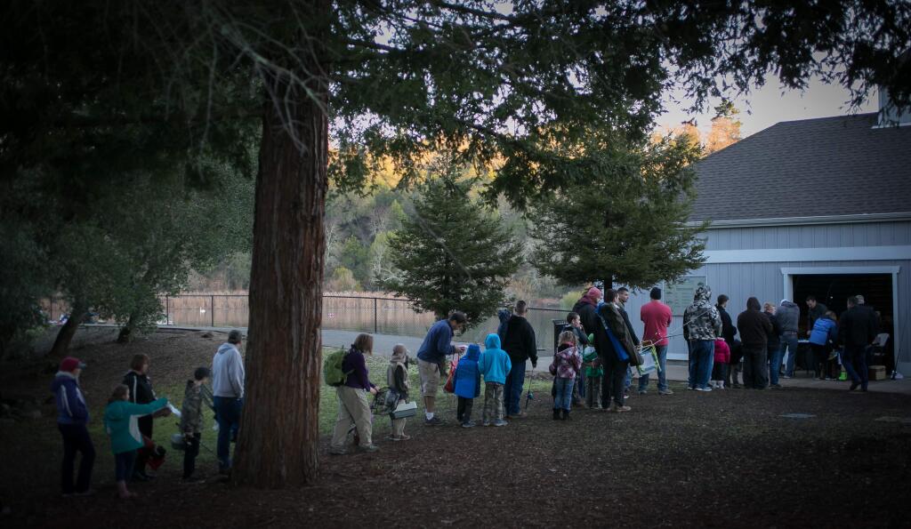 Participants line up to register for the 2016 Fishing Derby for Kids at Lake Ralphine Sunday, February 7, 2016, in Santa Rosa's Howarth Park. (Jeremy Portje / For The Press Democrat)