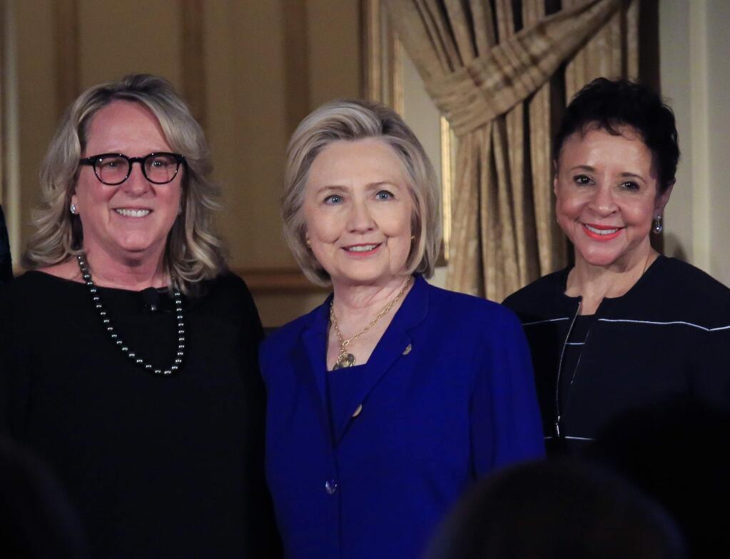 Former Secretary of State Hillary Clinton, center, stands between Sheila Johnson, right, founder and CEO of Salamander Hotels and Resorts and BET co-founder, and Deirdre Quinn, left, CEO and co-founder of Lafayette 148 New York, after Johnson and Quinn received the 2018 Elly Award, Monday June 18, 2018, in New York. Clinton on Monday called the Trump administration's “zero tolerance” policy that has separated children from their parents at the southern U.S. border “a moral and humanitarian crisis.” (AP Photo/Bebeto Matthews)