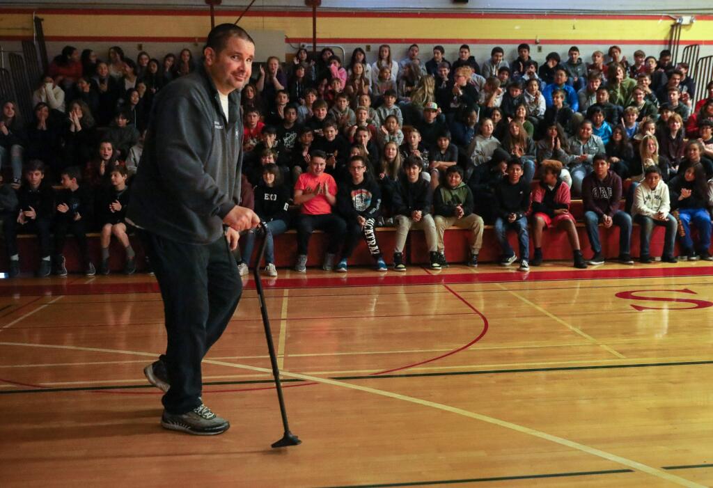 Bryan Stow shows students at Herbert Slater Middle School his progress in walking with a cane during his anti-bullying awareness presentation in Santa Rosa on Friday, December 6, 2019. Stow was attacked following a baseball game at Dodger Stadium in 2011.(Christopher Chung/ The Press Democrat)