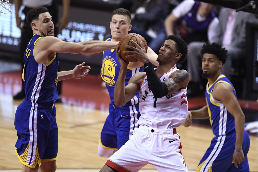 Toronto Raptors guard Danny Green (14) works against Golden State Warriors guard Klay Thompson (11) during the second half of Game 1 of the NBA Finals, Thursday, May 30, 2019, in Toronto. (Frank Gunn/The Canadian Press via AP)