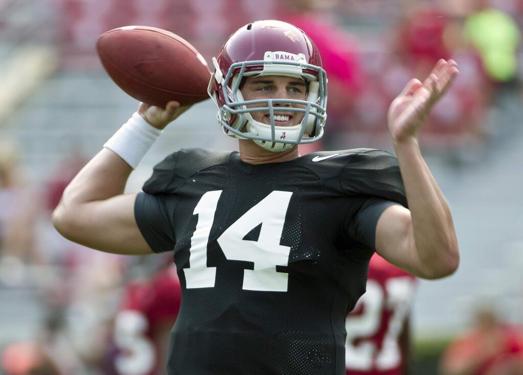 FILE - In this Aug. 9, 2015, file photo, Alabama quarterback Jake Coker sets back to throw the ball during an NCAA college football practice in Tuscaloosa, Ala. Alabama coach Nick Saban hasn't even given so much as a hint about who's his starting quarterback but it appears to be a three-man race. (AP Photo/Brynn Anderson, File)