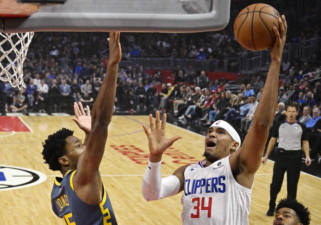 Los Angeles Clippers forward Tobias Harris, right, shoots as Golden State Warriors center Damian Jones defends during the first half of an NBA basketball game Monday, Nov. 12, 2018, in Los Angeles. (AP Photo/Mark J. Terrill)