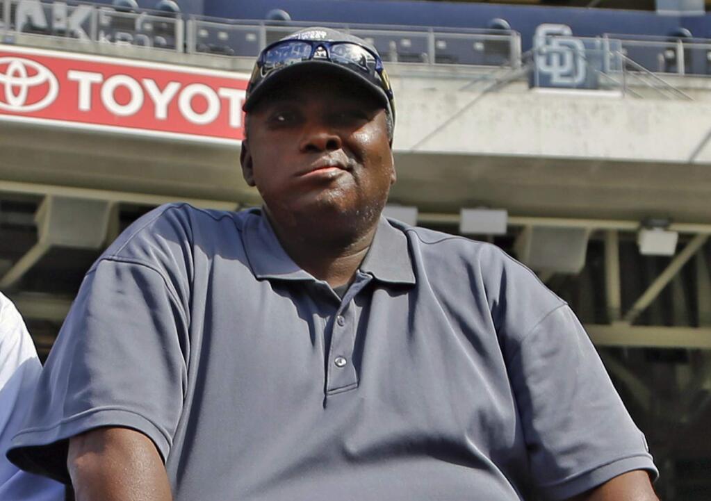 FILE - In this June 11, 2013 file photo, Hall of Famer Tony Gwynn watches batting practice during warmups prior to a baseball game between the San Diego Padres and the Atlanta Braves in San Diego. Gwynn's widow and two children filed a lawsuit Monday, May 23, 2016, seeking to hold the tobacco industry accountable for the Hall of Famer's death. (AP Photo/Lenny Ignelzi, File)