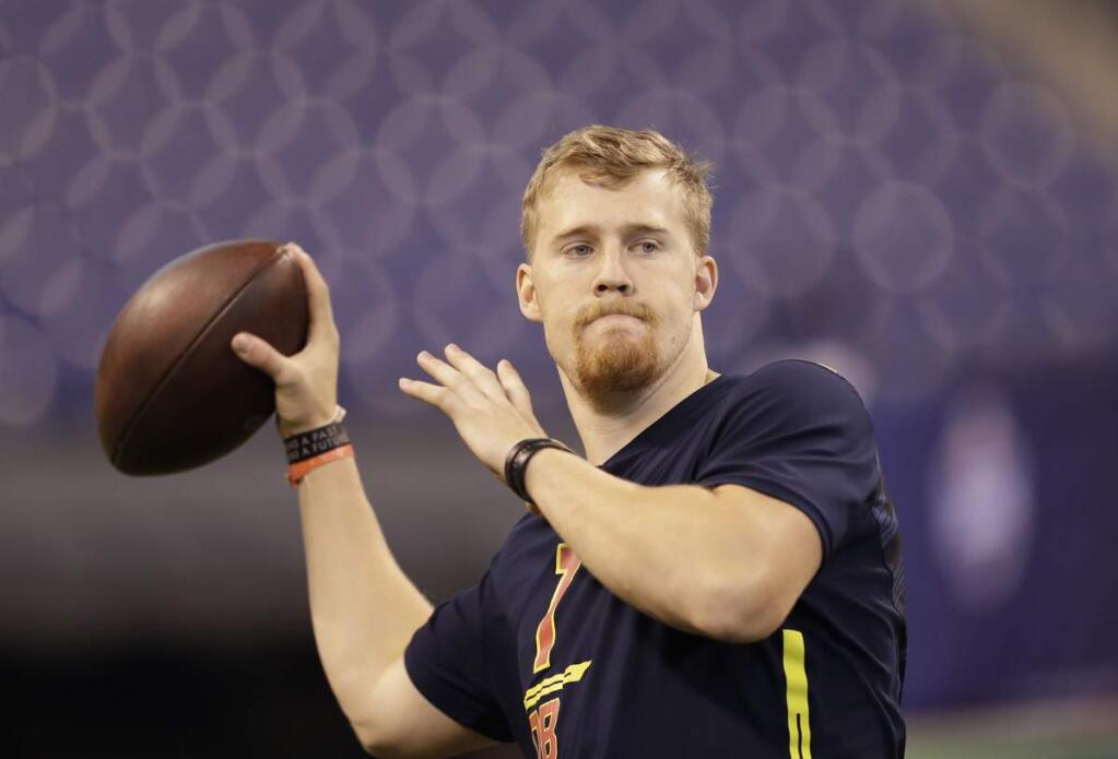 FILE - In this March 4, 2017 file photo, Iowa quarterback C.J. Beathard runs a drill at the NFL football scouting combine in Indianapolis. Beathard said at times it was frustrating watching other quarterbacks put up more prolific numbers but the tutelage he received in a pro-style offense under coach Kirk Ferentz and coordinator Greg Davis is what made him attractive to the San Francisco 49ers in the draft last week. 'I think it really benefited me coming from a pro-style offense,' Beathard said Thursday, May 4, 2017, on the eve of his first practice as a pro. (AP Photo/David J. Phillip, File)