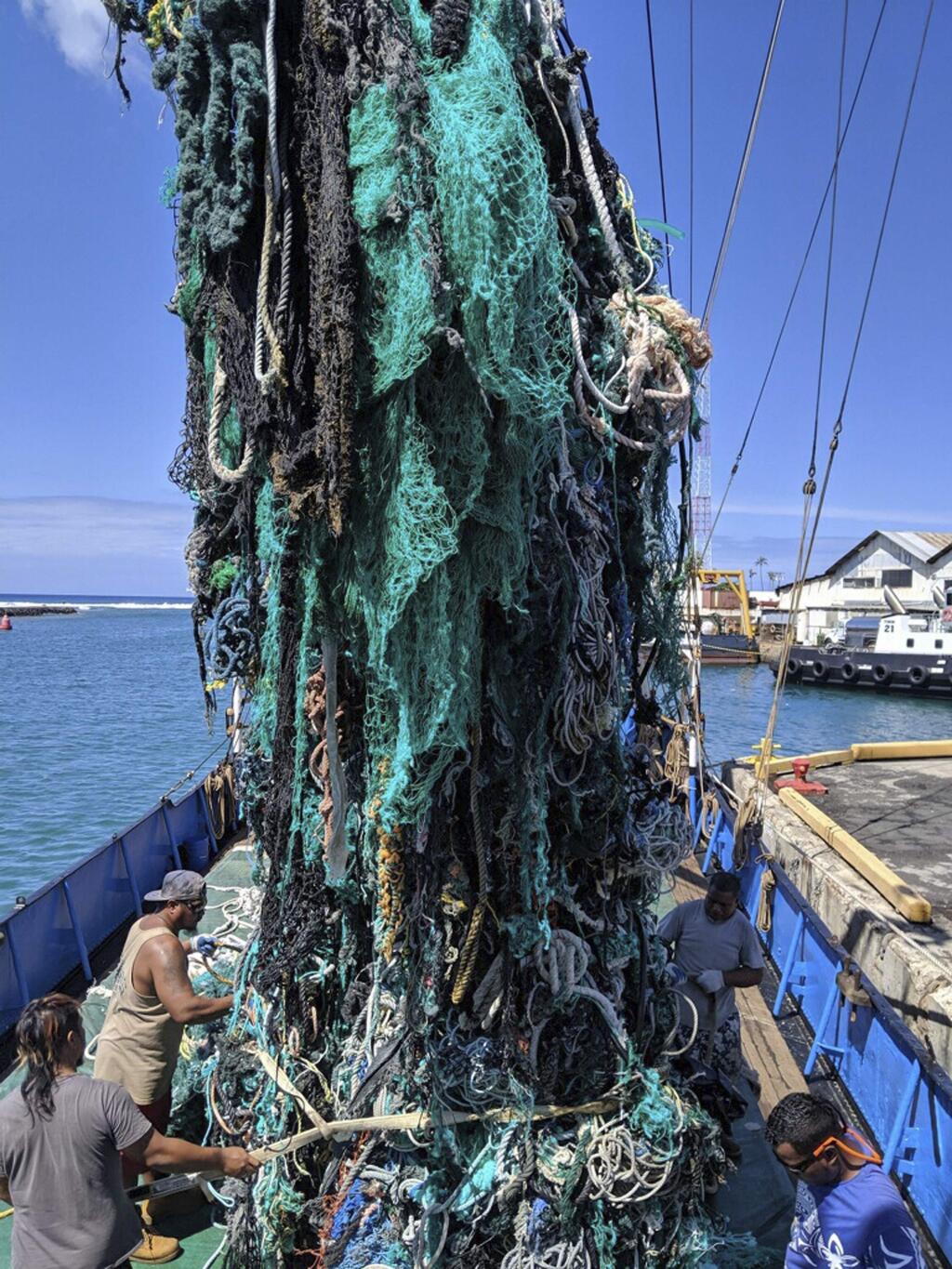 This photo taken June 18, 2019, provided by the Ocean Voyages Institute, shows a large net that was removed from the ocean during the Pacific gyre cleanup in Honolulu. Mariners on a sailing vessel hundreds of miles from the Hawaiian coast picked up more than 40 tons of abandoned fishing nets in an effort to clean a garbage patch in the Pacific Ocean, where the nets can entangle whales, turtles and fish and damage coral reefs. The crew of volunteers with the California-based nonprofit Ocean Voyages Institute fished out the derelict nets from a marine gyre between Hawaii and California known as the Great Pacific Garbage Patch during a 25-day expedition, the group's founder, Mary Crowley, announced Friday, June 28, 2019. (Greg Yoder/Ocean Voyages Institute via AP)