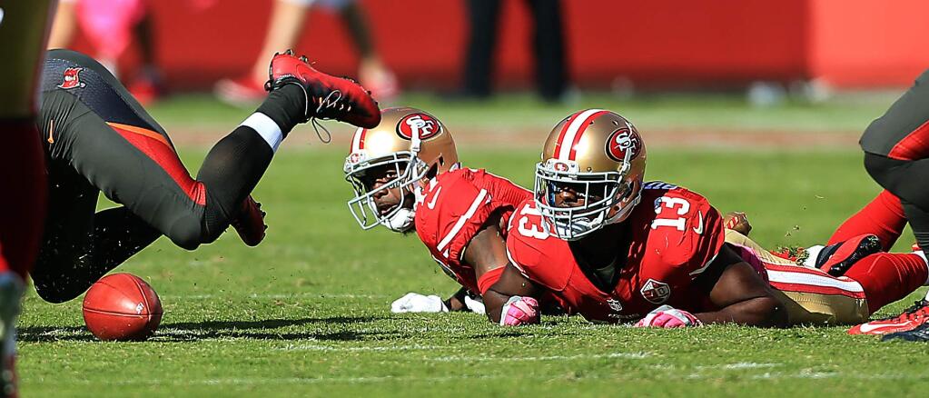 Indicative of the 49ers day, Quinton Patton, left signaled for a fair catch on a punt, but teammate Aaron Burbridge backed into him causing a fumble that Tampa Bay recovered and later scored as San Francisco fell to 1-6 with a 34-17 loss to the Buccaneers at Levi's Stadium in Santa Clara, Sunday Oct. 23, 2016. (Kent Porter / The Press Democrat) 2016