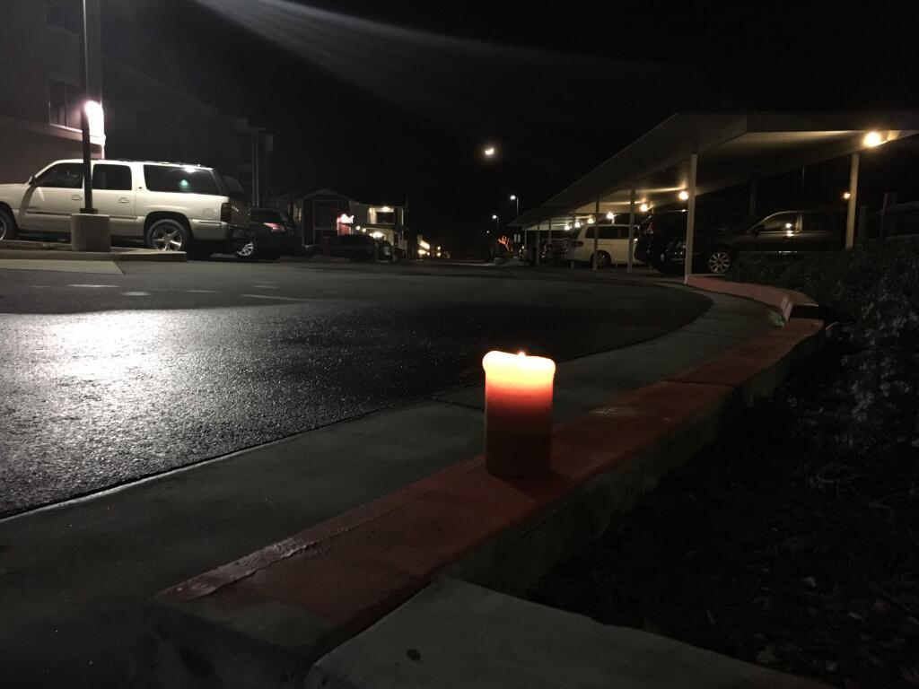 A candle sits near the site where a 4-year-old boy was fatally struck Friday evening, Feb. 12, 2016, by a vehicle in the Sonoma Gardens Apartments complex on Rodeo Lane. (Julie Johnson / PD)