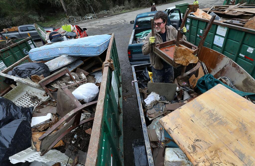 Michael Hodge dumps his flood-damaged materials at a debris dump site in Forestville on Monday, March 4, 2019. (CHRISTOPHER CHUNG/ PD)