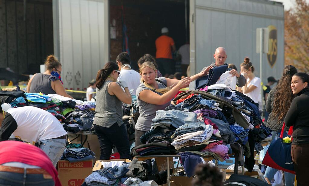 Volunteers sorts through thousands of donated items at Elsie Allen High School in Santa Rosa on October 13, 2017. (photo by John Burgess/The Press Democrat)