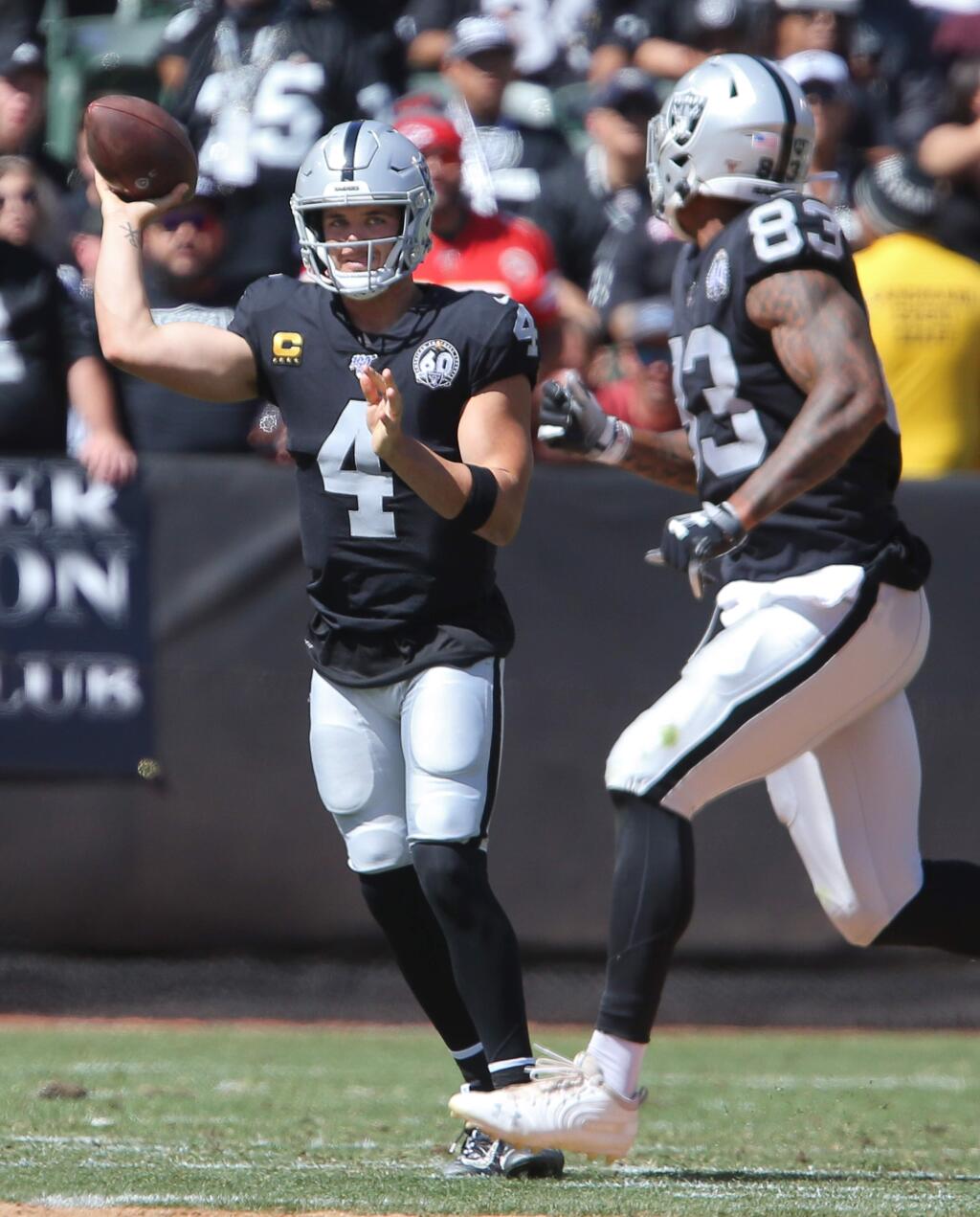 Oakland Raiders quarterback Derek Carr delivers a pass to Oakland Raiders tight end Darren Waller against the Kansas City Chiefs in Oakland on Sunday, September 15, 2019. (Christopher Chung/ The Press Democrat)