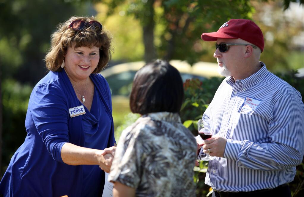 Deb Fudge, left, who is running for 4th District on the Board of Supervisors, greets Grace Christensen, left, and Dan Christensen, Jr., right, during Deb Fudge's Kick-Off Jamboree, held at the Geyserville Inn, Sunday, September 7, 2014. (Crista Jeremiason / The Press Democrat)