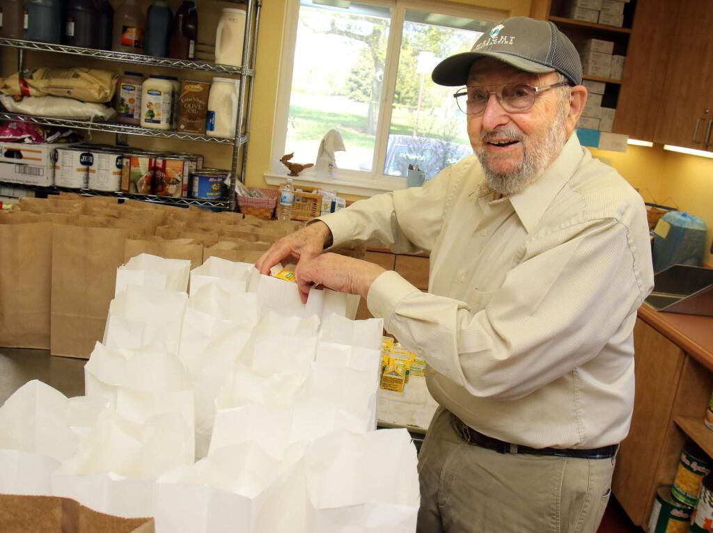 Volunteer Sid Lipton packs meals for Meals on Wheels food program for seniors at the senior center at Lucchesi Park in Petaluma on Tuesday March 31, 2015. (SCOTT MANCHESTER/ARGUS-COURIER STAFF)