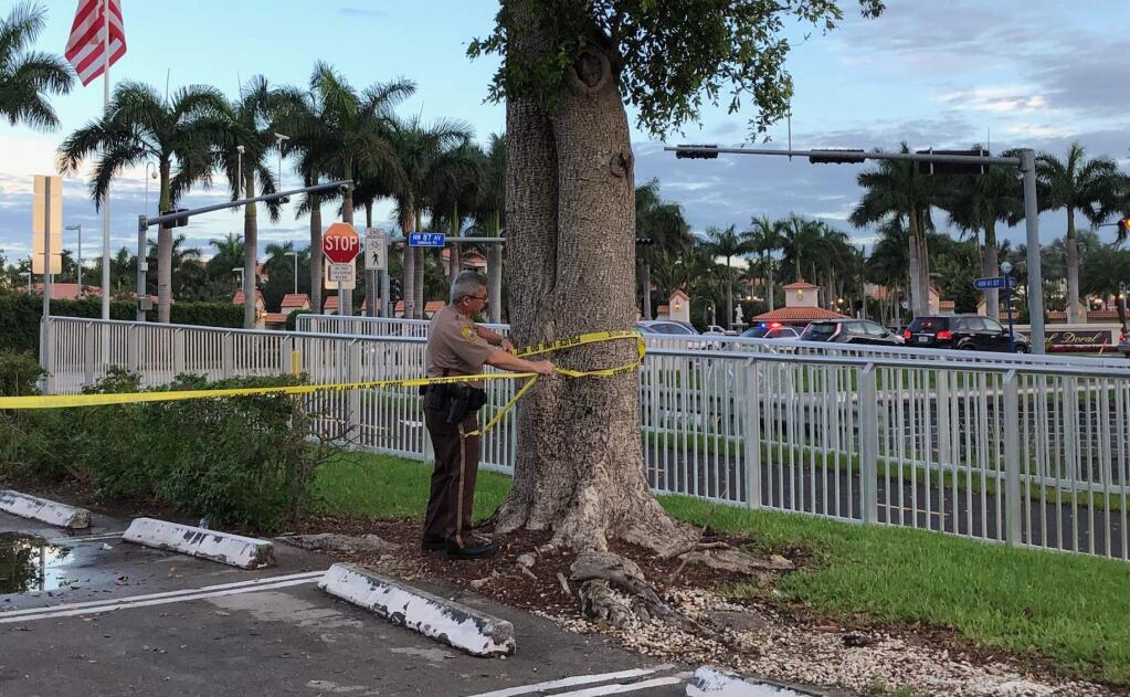 Police tape off an area by the Trump National Doral resort after reports of a shooting inside the resort Friday, May 18, 2018 in Doral, Fla. A man shouting about Donald Trump entered the president's south Florida golf course early Friday, draped a flag over a lobby counter and exchanged fire with police before being arrested, police said. One officer received an unspecified injury, officials said. (AP Photo/Frieda Frisaro)
