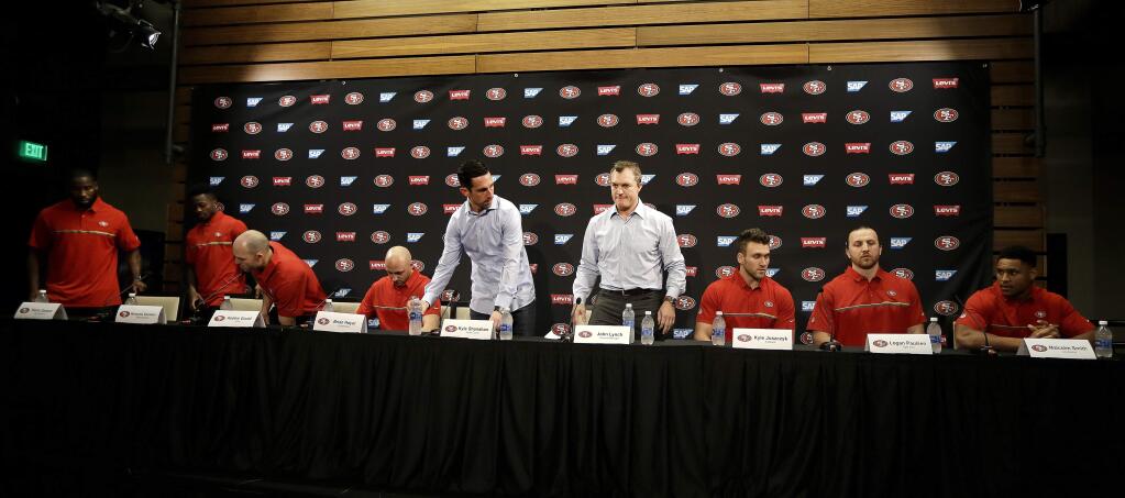 From left, the San Francisco 49ers' Pierre Garçon, Marquise Goodwin, Robbie Gould, quarterback Brian Hoyer, head coach Kyle Shanahan, General Manager John Lynch, Kyle Juszczyk, Logan Paulsen, and Malcolm Smith at the start of a media conference Friday, March 10, 2017, in Santa Clara. (AP Photo/Ben Margot)