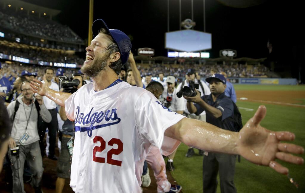 This June 18, 2014, file photo, Los Angeles Dodgers starting pitcher Clayton Kershaw celebrates his no-hitter against the Colorado Rockies in Los Angeles. Kershaw was a unanimous winner for his third NL Cy Young Award after leading the majors in victories and ERA and throwing a no-hitter. Kershaw earned the honor for the second year in a row, getting all 30 first-place votes in balloting by the Baseball Writers' Association of America announced Wednesday, Nov. 12. (AP Photo/Chris Carlson, File)