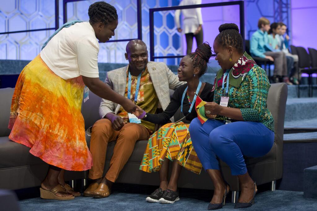 Afua Ansah, 14, of Accra, Ghana, center, is comforted by members of her family after incorrectly spelling her second word at the 2016 National Spelling Bee, in National Harbor, Md., Thursday, May 26, 2016. (AP Photo/Jacquelyn Martin)