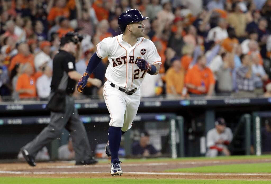 Houston Astros' Jose Altuve (27) watches his home run clear the fence during the first inning in Game 1 of baseball's American League Division Series against the Boston Red Sox, Thursday, Oct. 5, 2017, in Houston. (AP Photo/David J. Phillip)